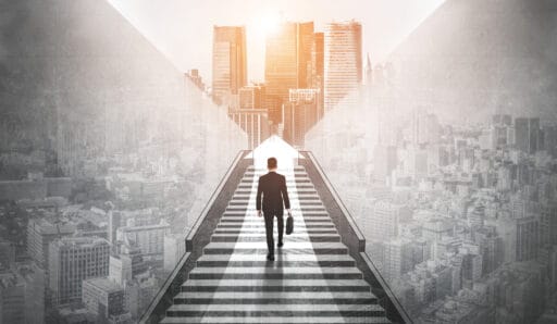 Ambitious business man climbing stairs to meet incoming challenge and business opportunity. The high stair represents the concept of career path success, future planning and business competitions.
